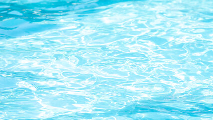 Fototapeta na wymiar Blue water in a swimming pool. Space for text