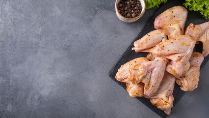 Raw marinated chicken wings ready to cook. Top view, space for text