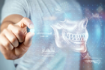Close-up male hands holding a white pill, taking medication, treatment, gray background. Medical theme, vitamins, health care.