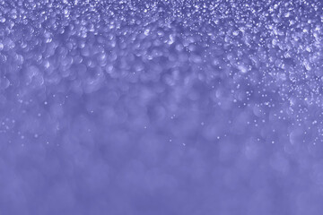 Very peri color of the year 2022, violet sparkling glitter bokeh background, christmas abstract defocused texture. Holiday lights