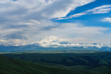 Fototapeta premium View of Elbrus and the Bermamyt plateau in the Karachay-Cherkess Republic, Russia. The Caucasus Mountains.