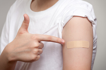 An adhesive plaster for the injection site protection glued on the hand of young boy