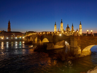 Naklejka premium El Pilar de Zaragoza. A view of the Basilique of Zaragoza from the other side of the river Ebro. Zaragoza is in the region of Aragon, Spain.