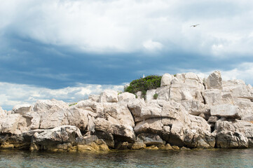 Small isolated rocky islet with seagulls in Adriatic sea, Croatia, Zadar region