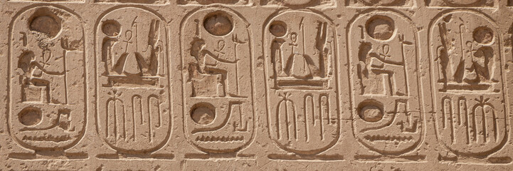 Relief details and Egyptian hieroglyphs at Karnak temple complex in Luxor - obrazy, fototapety, plakaty