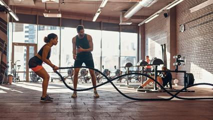Naklejka na ściany i meble Trainer tell to girl do exercise with sports rope