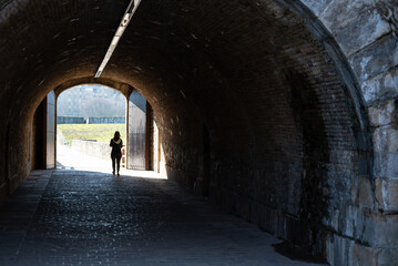 Woman walking through a passageway