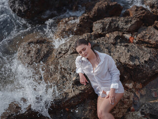 lifestyle swimwear photo-shoot of beautifaul woman on rocky beach