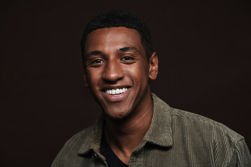 Obraz premium Young black man dressed in shirt smiling and looking aside