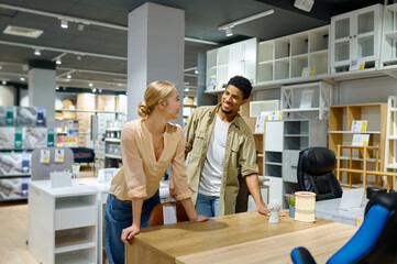 Couple looking for table at furniture store