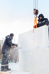 Workers in winter workwear installing ice panels