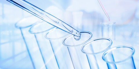 Pipette and test tubes with laboratory scene in background - 483933506