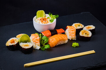 sushi on a stone platter, asian food.