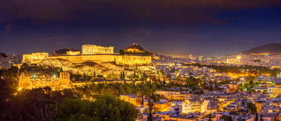 Panorama of night Athens with Acropolis hill crowned by the Parthenon, Athens, Greece, Europe. The Old Acropolis is the main attraction of Athens.