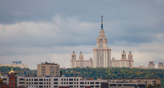 travel to moscow, russia, main tourist attractions. view of Stalin skyscraper against backdrop of green trees in park. Lomonosov Moscow State University