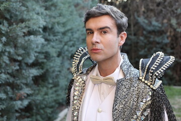 Eccentric fashionable man wearing jewels on extravagant outfit