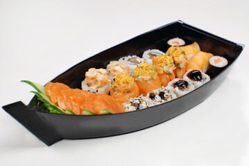 Japanese food combo of sushis and sahimis in white background
