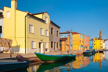 Fototapeta na wymiar VENICE, ITALY: Burano island, architectural details of multi-colored houses of locals. Traditional colorful houses - one of attractive tourist objects in the Venetian lagoon
