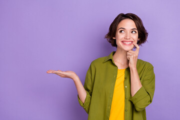 Photo of young cheerful woman curious look empty space ads decision discount recommend isolated over violet color background