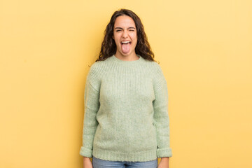 hispanic pretty woman with cheerful, carefree, rebellious attitude, joking and sticking tongue out,...