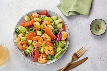 Delicious fresh salad with shrimp prawns, grapefruit, avocado, cucumber and green salad. Healthy food.