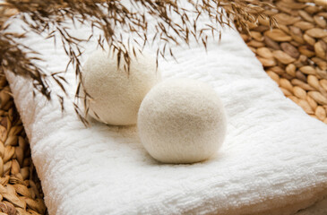 Natural wool dryer balls for more soft clothes while tumble drying in washing machine concept....