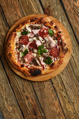 Meat Italian pizza with roast beef, steak slices, melted cheese, with olive slices and cheddar cheese. Close up, macro. Pizza time concept.
