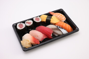 Sushi Set nigiri and sushi rolls with soy sauce and chopsticks Japanese food isolated in white background