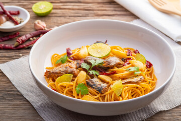 Spaghetti with Canned Mackerel and Dried Chili garlic in white plate.Fusion food