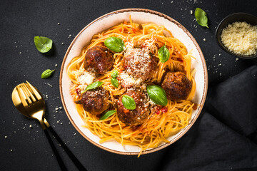 Pasta with Meatballs in tomato sauce on dark stone table. Traditional italian pasta.