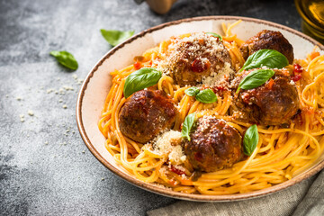 Pasta with Meatballs in tomato sauce, basil and parmesan. Close up.
