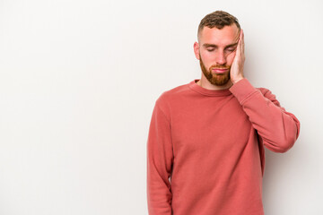 Fototapeta premium Young caucasian man isolated on white background who feels sad and pensive, looking at copy space.