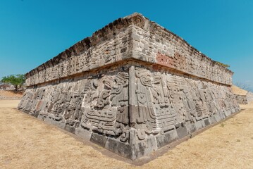 The wall of the ancient pyramid on the top of the mountain, masonry, bas-reliefs and images of the ancient Indians. architecture. City in Mexico Xochicalco