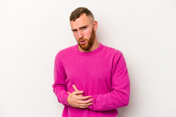 Young caucasian man isolated on white background having a liver pain, stomach ache.