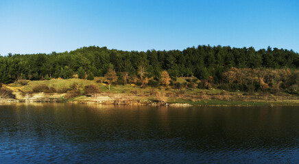 Landscape view of pine trees from over the Bayramic dam lake