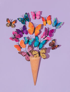 Colorful Butterflies Flying From Ice Cone On Pastel Purple Background. 80s, 90s Retro Aesthetic Romantic Spring Or Summer Concept. Minimal Fashion Idea.