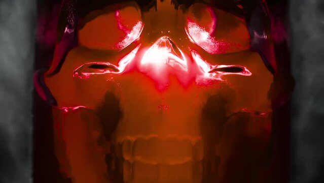 Glowing Red Glass Skull. Ice skull glowing with a red light in the vapor of evaporating gas. Slow Motion 240 fps