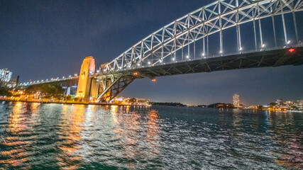Sydeny Harbour Bridge at night, view from a moving tourist boat