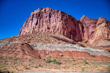 Red Mountains in Capitol Reef National Park under a blue summer sky.