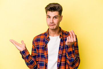 Young caucasian man isolated on yellow background showing that she has no money.