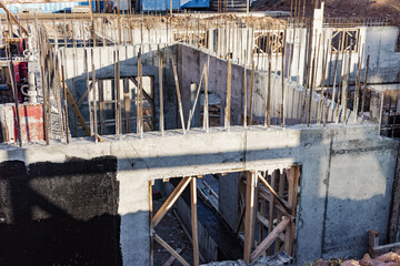 Reinforced concrete foundation of a modern monolithic residential building. Prepared formwork with reinforcing mesh for pouring concrete. Monolithic construction technologies.