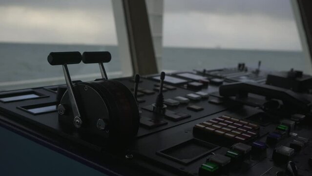 Ship's bridge. Control panel. Throttle. Pitching. Sea in background