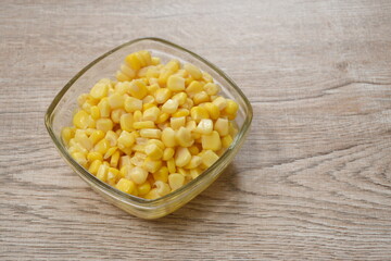 steamed sweet corn seed in salt water on bowl