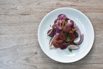 spicy and sour Chinese pork sauce with shallot salad on plate