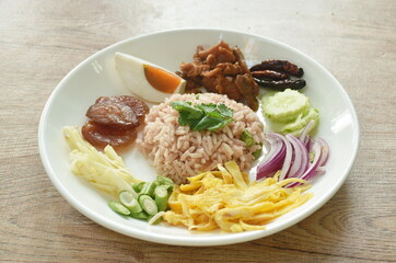 fried rice mixed with shrimp paste eat couple egg and vegetable on plate