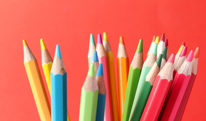 Colored pencils on red background
