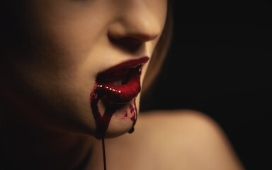 Woman with bloody mouth closeup photo