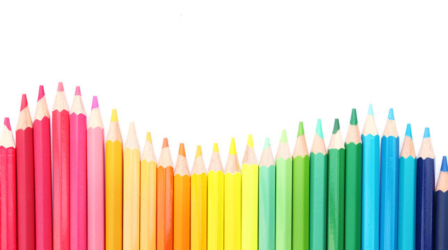 Colored pencils lined up on white paper background. Copy space. Back to school. Office supplies.