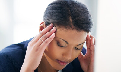 When stress sabotages success. Shot of a young businesswoman experiencing stress while working in a...