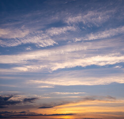 Obraz premium Picturesque evening sky with streaks of white cirrus clouds and sunlight. Sky replacement texture.